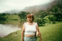 a woman standing in front of a body of water