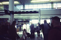 a group of people standing in line at an airport