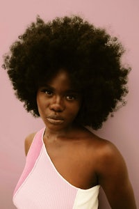 a black woman with afro hair posing for a photo