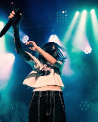 a woman holding a microphone on stage