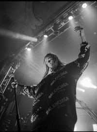 a black and white photo of a woman on stage