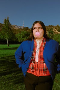 a woman blowing bubbles in a park